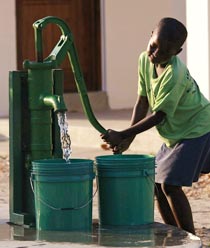 A child of the Village of Joy drawing water from the fountain