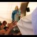 A child hands Swami Roberto a Madonna to get her blessed. Then I learned that the child had found that Madonna days before in the rubbish – Ramia Riccardo